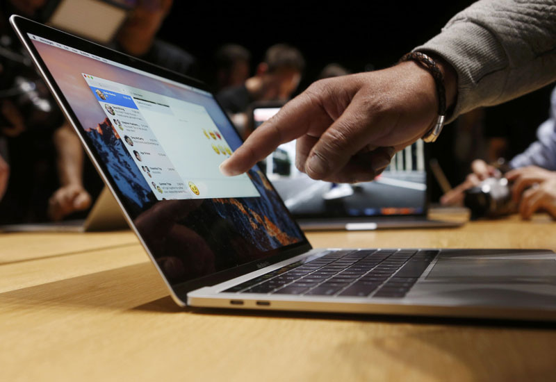 a guest points to a new macbook pro during an apple media event in cupertino california u s october 27 2016 photol reuters