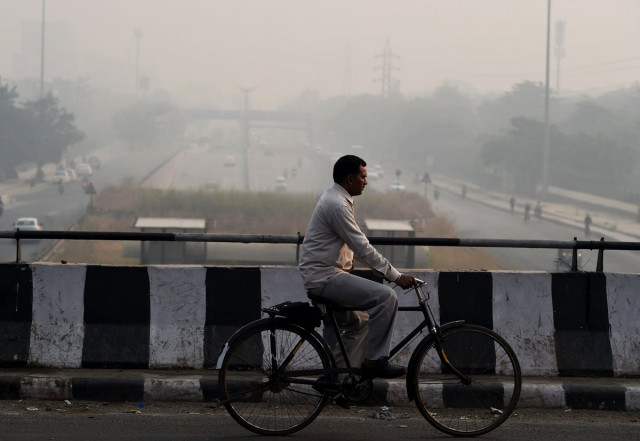 an indian cyclist rides over a bridge as smog envelopes new delhi on october 31 2016 the day after the diwali festival photo afp an indian cyclist rides over a bridge as smog envelopes new delhi on october 31 2016 the day after the diwali festival photo afp
