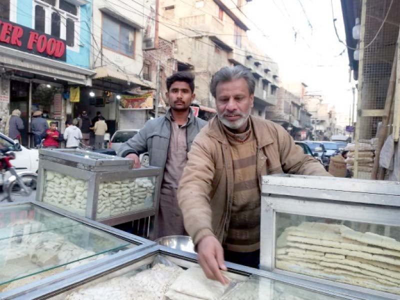 a vendor sells sweet items coated with sesame seeds on his pushcart in rawalpindi photo express