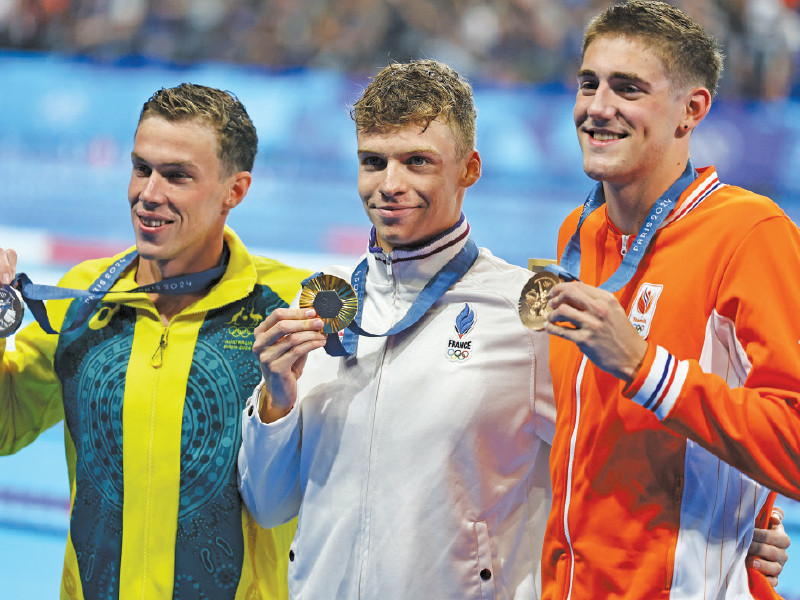 gold medallist leon marchand of france is seen on the podium along with silver medallist zac stubblety cook of australia and bronze medallist caspar corbeau of netherlands photo reuters