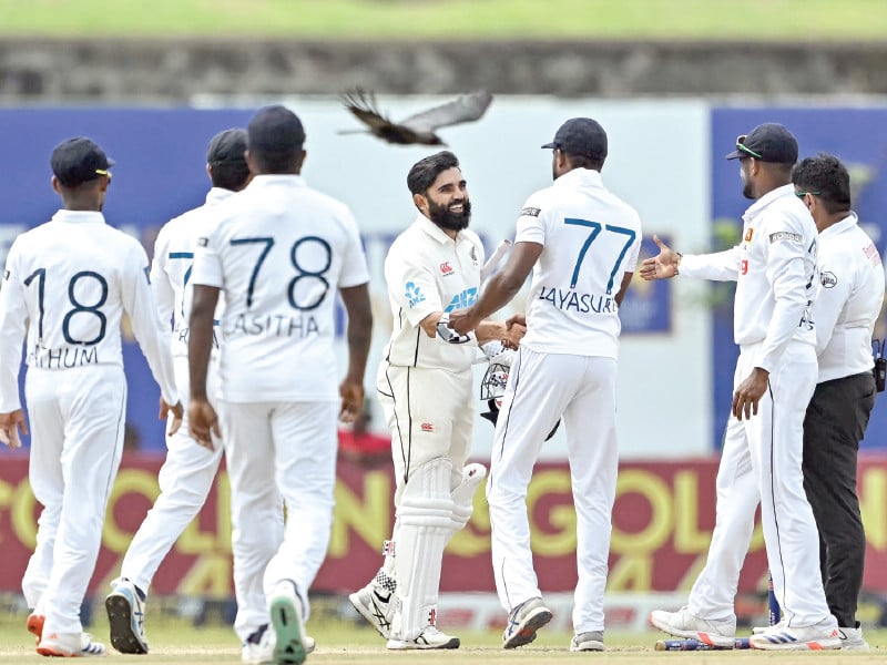 new zealand s ajaz patel c greets sri lanka s players after the end of the first test at galle international cricket stadium on monday photo afp