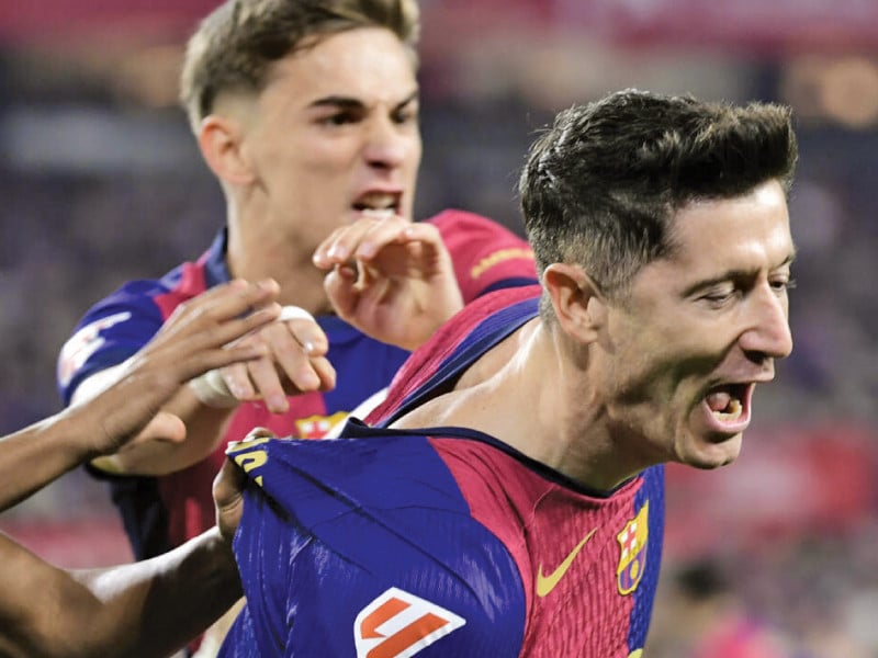 barcelona s polish forward robert lewandowski r celebrates opening the scoring at sevilla photo afp