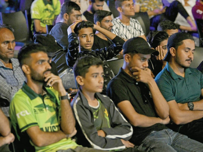 cricket fans in karachi react as they watch a live broadcast of the icc champions trophy match between india and pakistan on a big screen on sunday night photo afp