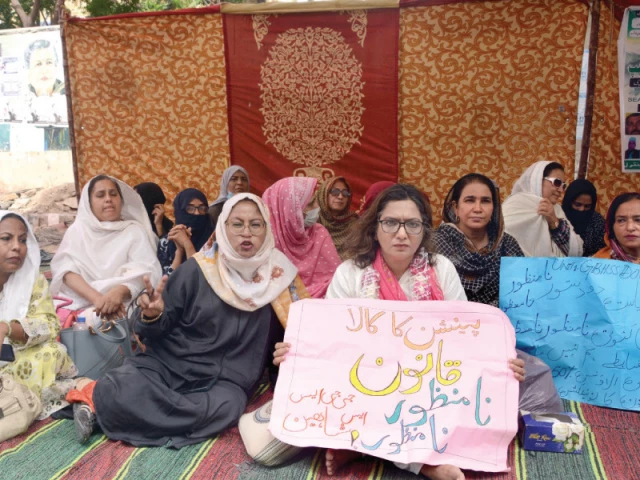government employees hold placards denouncing pension deductions at the hunger strike camp outside kpc photo jalal qureshi express