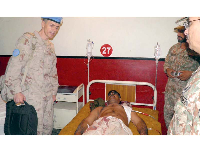 unmogip members inquiring after the health of an injured man at a hospital during their visit to loc photo app