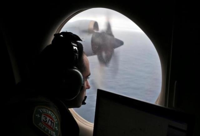 flight officer rayan gharazeddine looks out of a royal australian air force raaf ap 3c orion as it flies over the southern indian ocean during the search for missing malaysian airlines flight mh370 march 22 2014 photo reuters