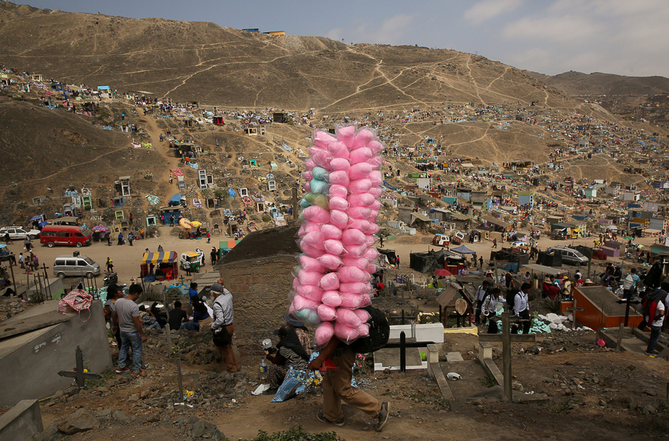 street vendor sells candy floss as people visit tombs of relatives and friends at 039 nueva esperanza 039 new hope cemetery during the day of the dead celebrations in villa maria del triunfo on the outskirts of lima peru photo reuters