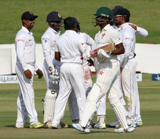 zimbabwe 039 s bowler donald tiripano r walks off the field after loosing his wicket during the fifth day of the first cricket test match between zimbabwe and sri lanka at the harare sports club on november 2 2016 photo afp