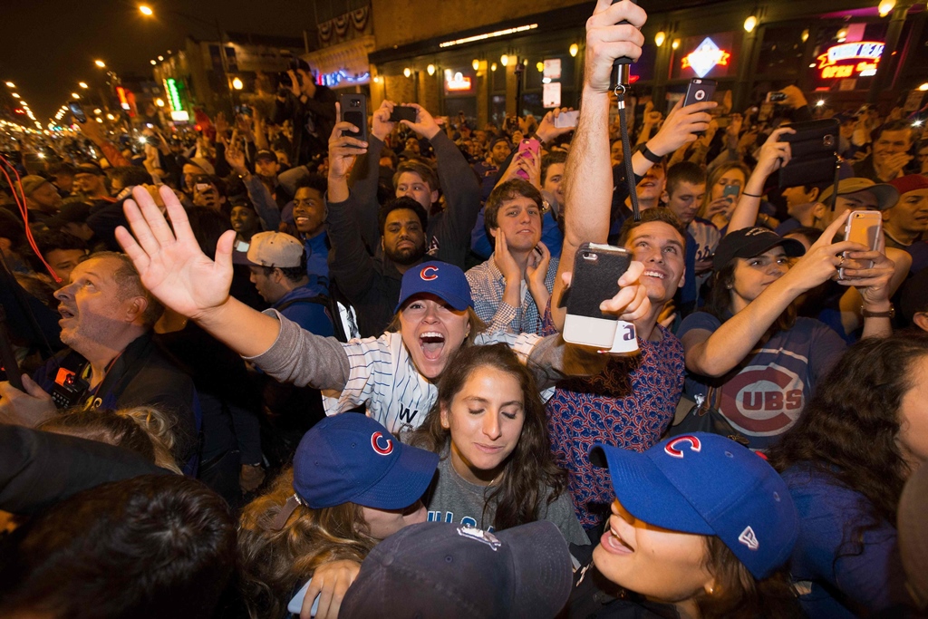 chicago fans take to the streets to celebrate the chicago cubs 8 7 victory over the cleveland indians photo afp