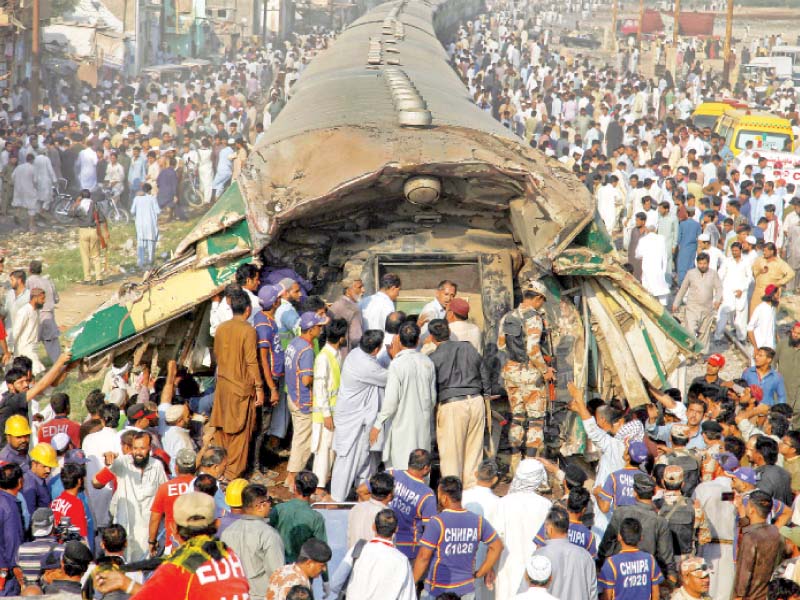 rescue workers and bystanders retrieve bodies from a train mangled in the collision photo athar khan express