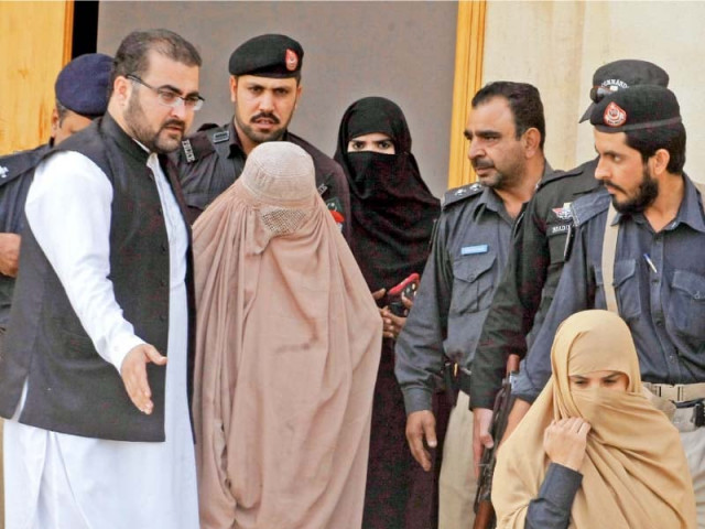 sharbat gula is being escorted by policemen after an immigration court in peshawar asked the authorities to deport her photo muhammad iqbal express