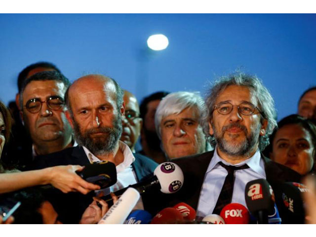 can dundar r editor in chief of cumhuriyet accompanied by his ankara bureau chief erdem gul talks to media as they leave at the justice palace in istanbul turkey may 6 2016 photo reuters