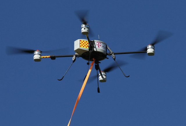 new quadcopter tech allows drones to recharge on power lines new quadcopter tech allows drones to recharge on power lines