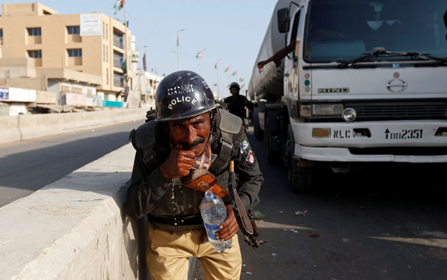 a policeman washes away the effects of tear gas fired by police after shias blocked the main national highway and railway tracks to protest the detention of their religious workers in karachi november 7 2016 photo reuters