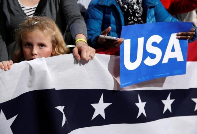 a young girl listens as u s president barack obama campaigns for democratic presidential nominee hillary clinton at the university of new hampshire in durham new hampshire us photo reuters