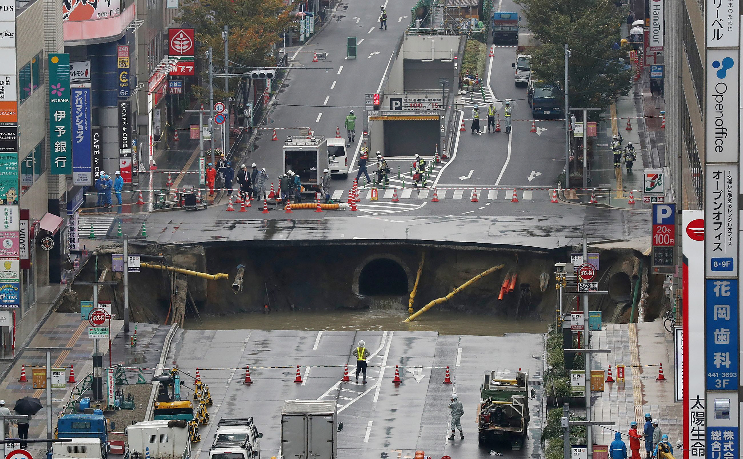 a giant sinkhole is seen in a five lane urban boulevard exposing support columns of nearby buildings at a traffic intersection in fukuoka southwestern japan photo afp