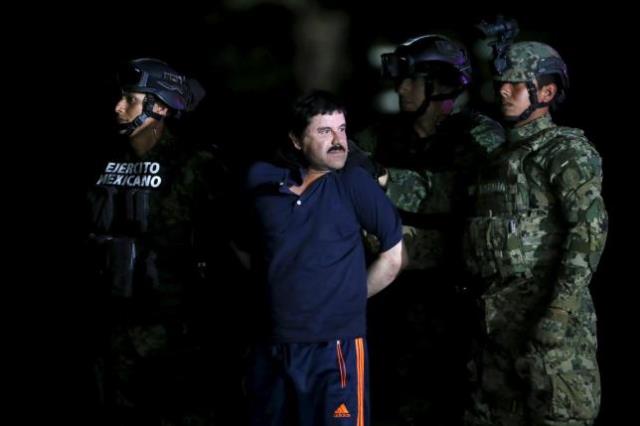 joaquin 039 039 el chapo 039 039 guzman is escorted by soldiers during a presentation at the hangar belonging to the office of the attorney general in mexico city mexico january 8 2016 photo reuters