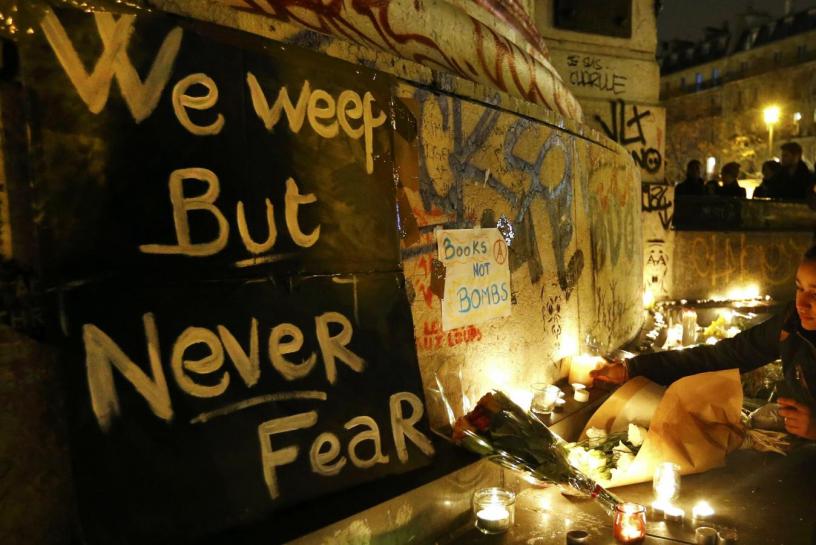 flowers and candles are placed near the scene of a shootin the day after a series of deadly attacks in paris november 14 2015 photo reuters