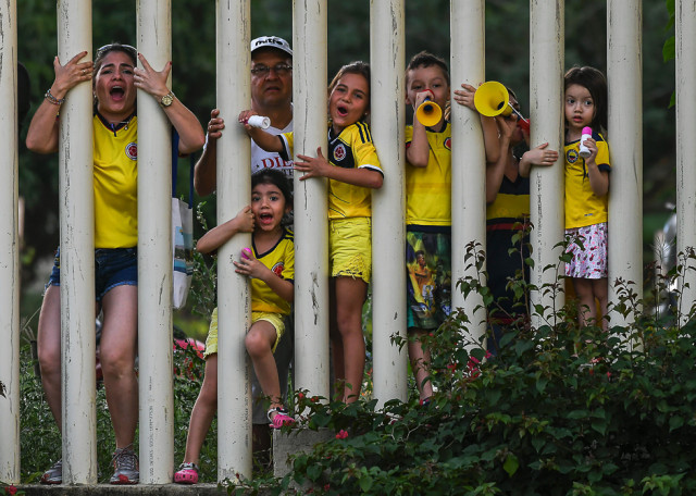 supporters of the colombian national football team cheer as they watch a training session at the university autonoma in barranquilla colombia photo afp