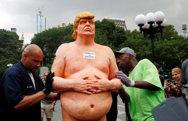 new york city park workers move a naked statue of donald trump that was left in union square park in new york city aug 18 photo reuters