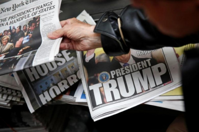 a man hands a newspaper to a customer at a news stand in new york u s november 9 2016 photo reuters a man hands a newspaper to a customer at a news stand in new york u s november 9 2016 photo reuters