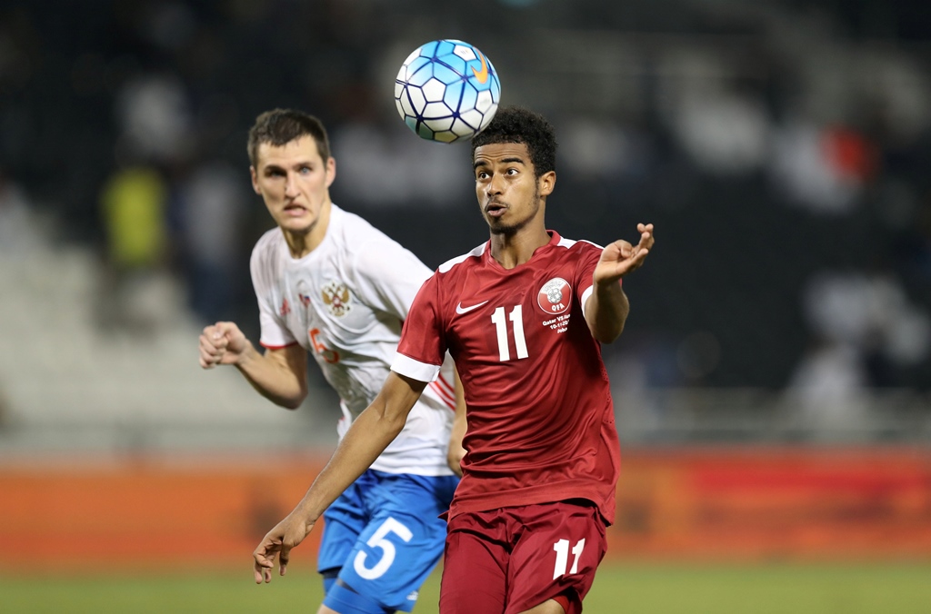 qatar 039 s akram afif r fights for the ball with russia 039 s viktor vasin photo reuters ibraheem al omari