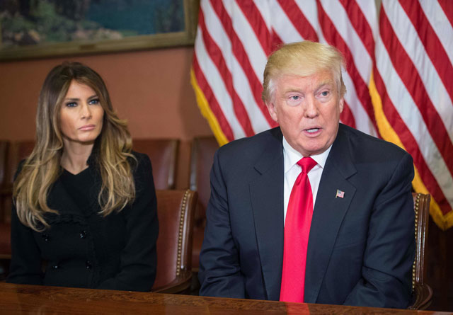 melania trump listens to her husband us president elect donald trump speak to the press at the us capitol in washington dc on november 10 2016 photo afp