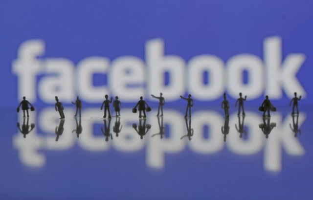 3d printed models of people are seen in front of a facebook logo in this photo illustration taken june 9 2016 photo reuters