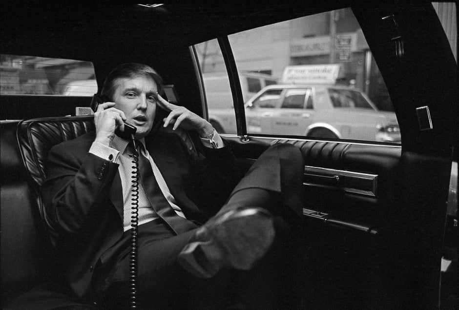 donald trump on the phone in his car after announcing plans for development of the west side of midtown manhattan at the hyatt hotel on 42nd street and lexington avenue in new york on nov 18 1985