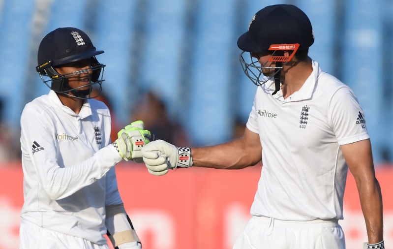 england 039 s captain alastair cook r bumps fists with teammate haseeb hameed on the fourth day of the first test cricket match between india and england at the saurashtra cricket association stadium in rajkot on november 12 2016 photo afp