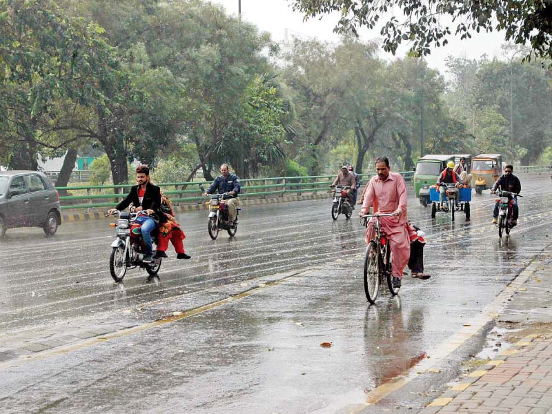 people commute in lahore amid a drizzle photo express