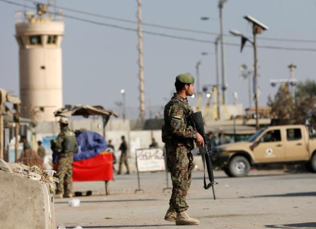 afghan national army ana soldiers keep watch outside the bagram airfield entrance gate after an explosion at the nato air base north of kabul afghanistan november 12 2016 photo reuters