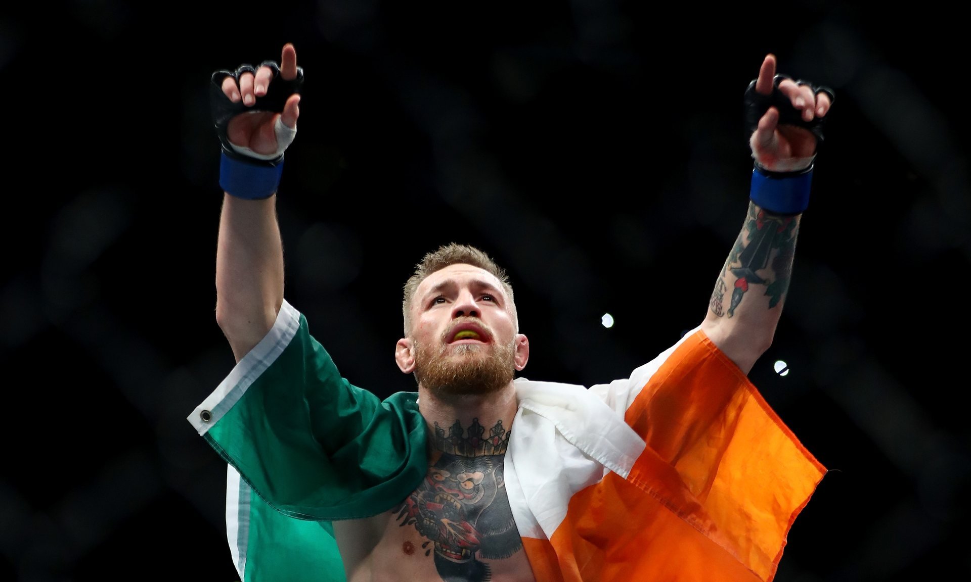 conor mcgregor celebrates with the irish flag photo courtesy getty images