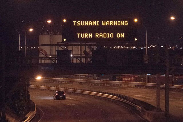 a tsunami warning alert is seen on a notice board above state highway 1 in wellington early on november 14 2016 following an earthquake centred some 90 kilometres 57 miles north of new zealand 039 s south island city of christchurch photo afp