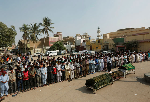 relatives attend funeral prayers for men who were killed in an explosion at the shah noorani shrine in baluchistan in karachi november 13 2016 photo reuters