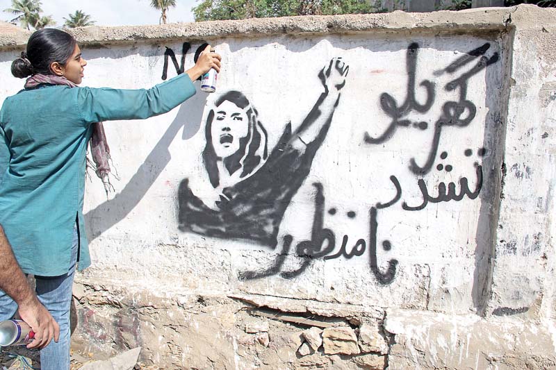 young men and women took to street art and painted slogans and images against domestic violence street harassment identity crisis stereotypes and rape in gulshan e iqbal north nazimabad saddar tower ii chundrigarh road karachi press club and numaish photos ayesha mir express