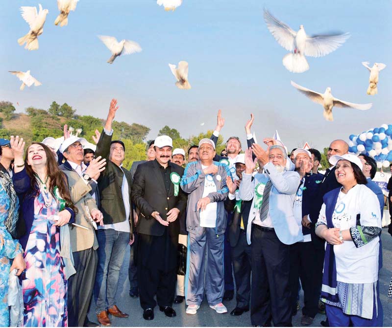 president mamnoon hussain releases pigeons at the start of a world diabetes day walk at aiwan e sadr photo app