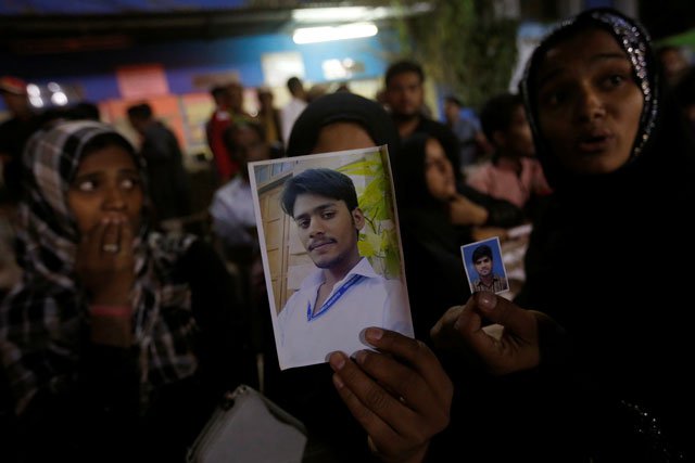 family members show pictures of missing relatives after an explosion in at the shah noorani shrine in baluchistan outside a hospital in karachi november 12 2016 photo reuters