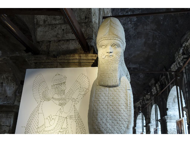 a full scale reproduction shows the human headed bull from the north west palace in nimrud iraq presented at an exhibition at the ancient colosseum in rome on october 6 2016 photo afp