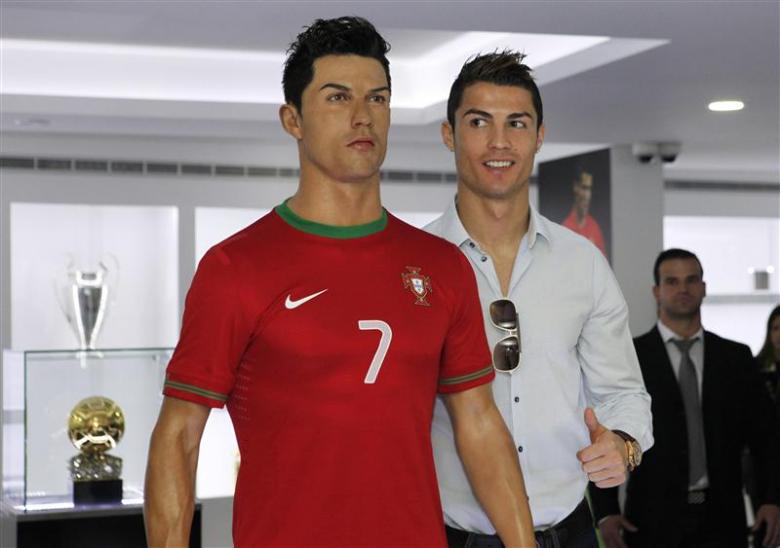 cristiano ronaldo who plays for real madrid and portugal 039 s national soccer team poses with his statue during the inauguration of his museum in funchal december 15 2013 photo reuters