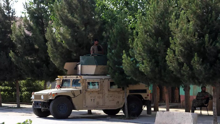 afghan security forces stand guard along a road in kunduz photo afp