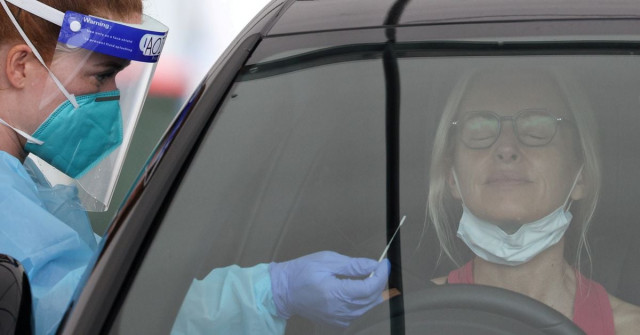 a medical worker swabs a member of the public at the bondi beach drive through coronavirus disease covid 19 testing centre as the city experiences an outbreak in sydney australia photo reuters a medical worker swabs a member of the public at the bondi beach drive through coronavirus disease covid 19 testing centre as the city experiences an outbreak in sydney australia photo reuters
