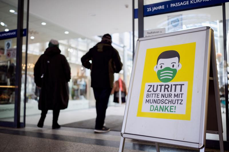 a banner in front of the mall reading entering only with a face mask is seen amid the coronavirus disease covid 19 pandemic at the baltic sea resort timmendorfer strand germany april 13 2021 photo reuters