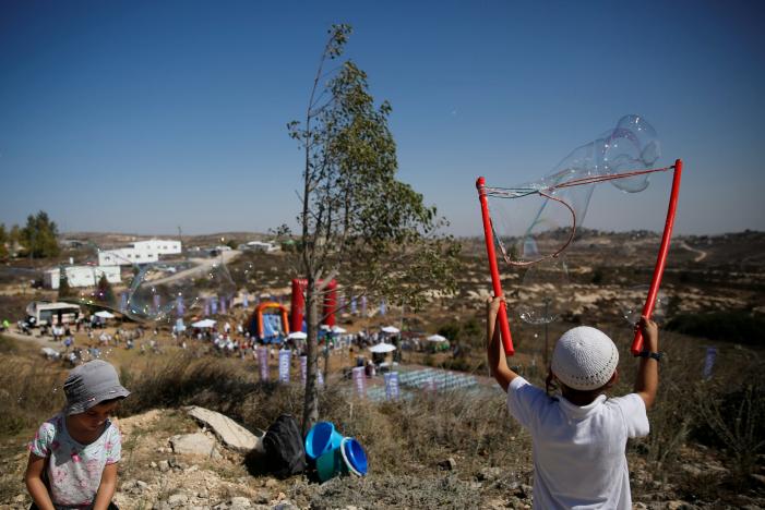 children play during an event organised to show support for the jewish settler outpost of amona in the west bank that was built without israeli state authorisation and which israel 039 s high court ruled must be evacuated and demolished by the end of the year as it is built on privately owned palestinian land photo reuters