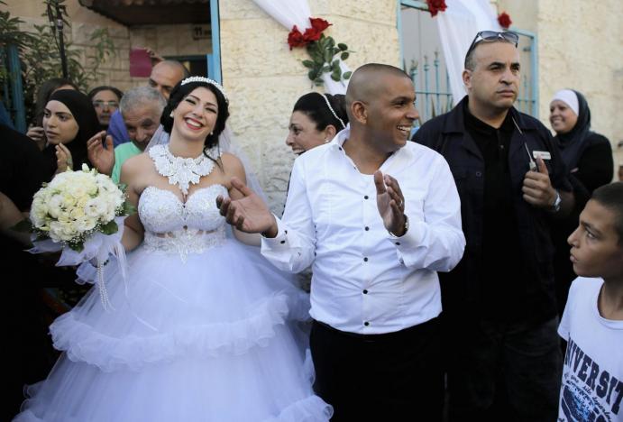 groom mahmoud mansour 26 c and his bride maral malka 23 celebrate with friends and family before their wedding in mahmoud 039 s family house in jaffa south of tel aviv photo reuters