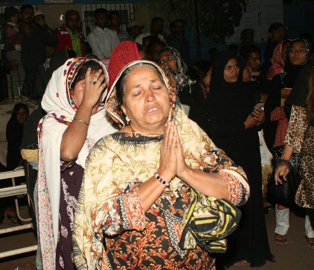 relative of a victim of shah noorani shrine blast cries at civil hospital karachi on november 13 2016 photo mohammad noman express