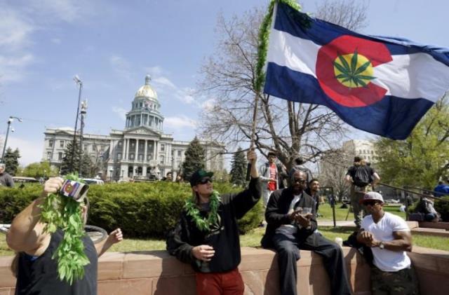 a man waves a colorado flag with a marijuana leaf on it at denver 039 s annual 4 20 marijuana rally in front of the state capitol building in downtown denver april 20 2015 photo reuters