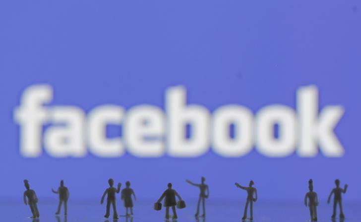 3d printed models of people are seen in front of a facebook logo in this photo illustration taken june 9 2016 photo reuters