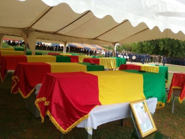 coffins are seen draped in malian flags at a funeral for 17 soldiers who were killed in segou mali july 21 2016 picture taken july 21 2016 photo reuters