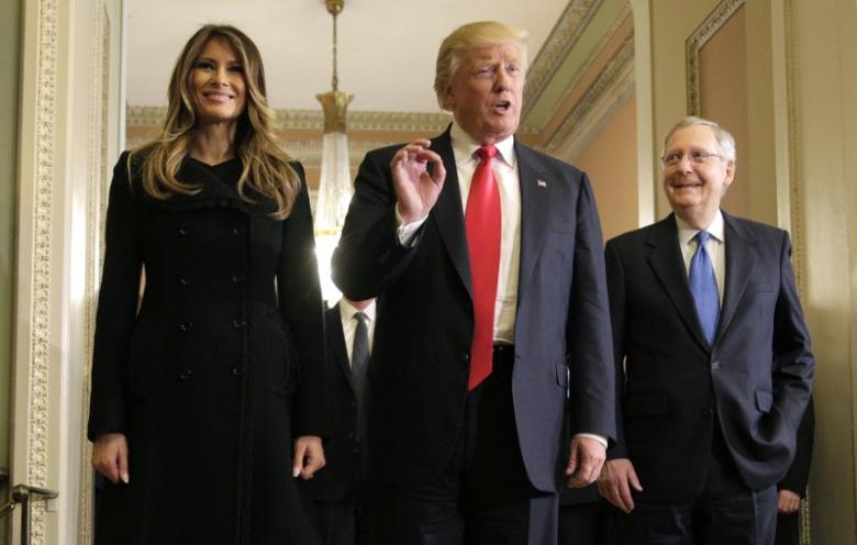 us president elect donald trump c answers questions as his wife melania trump and senate majority leader mitch mcconnell r ky watch on capitol hill in washington photo reuters